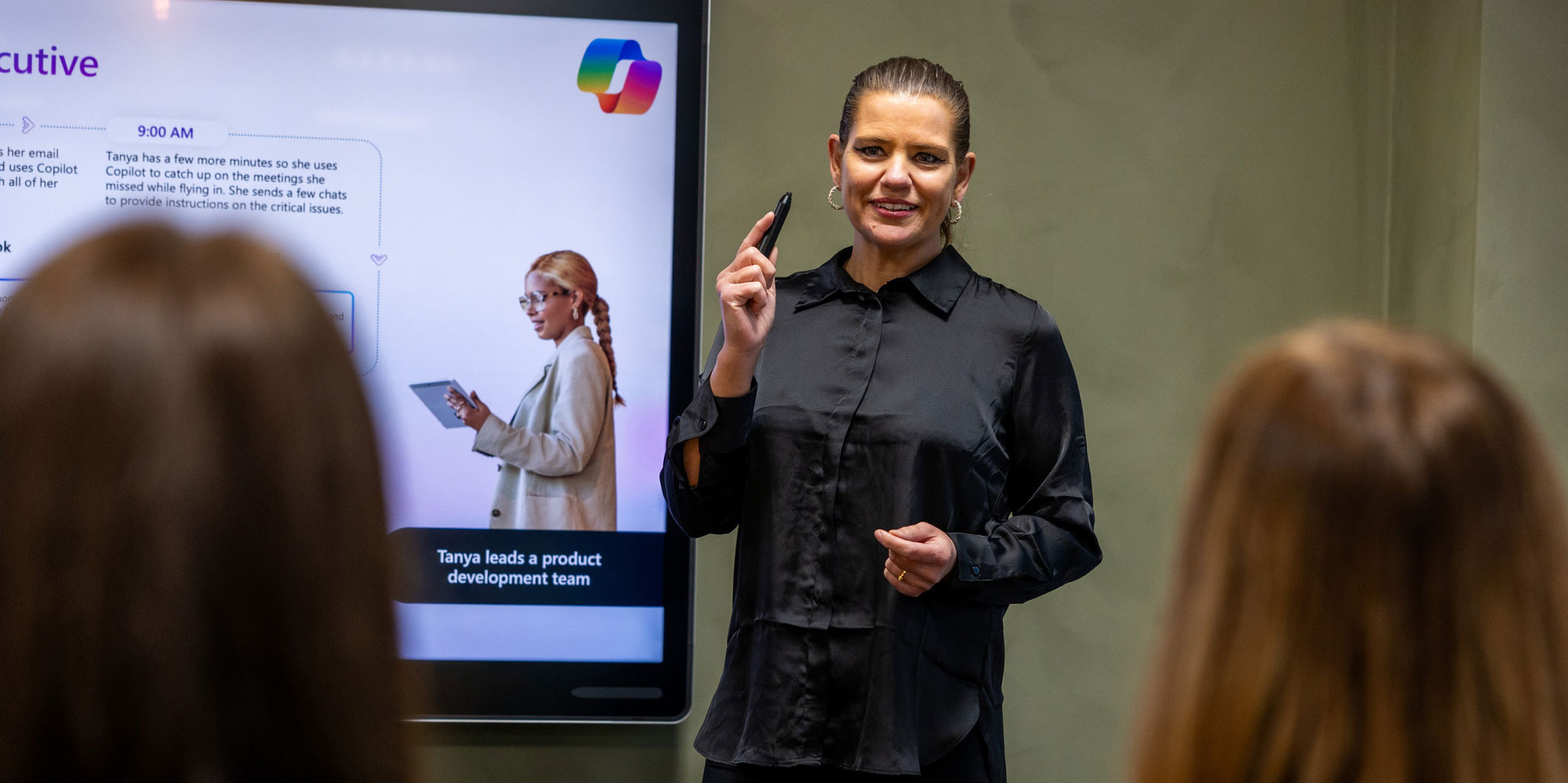 Woman standings in front of screen with copilot