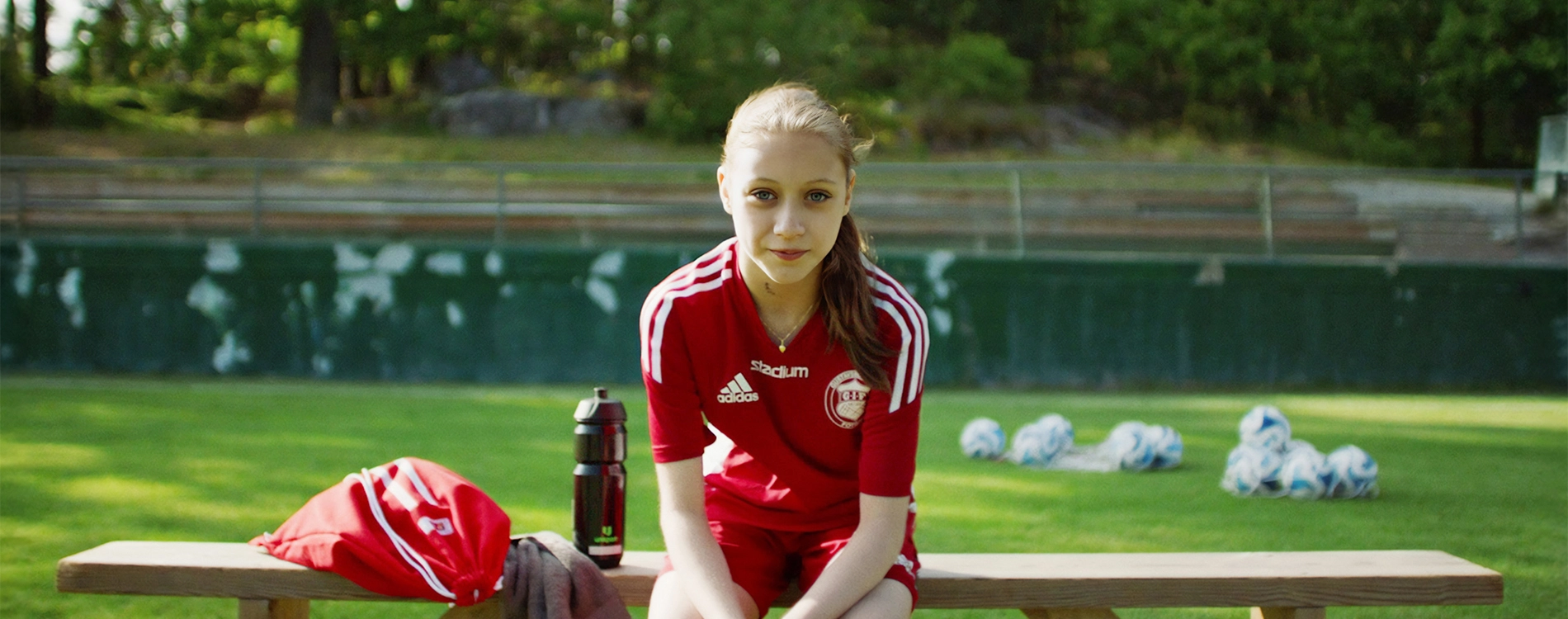 Football Girl Sitting On Bench
