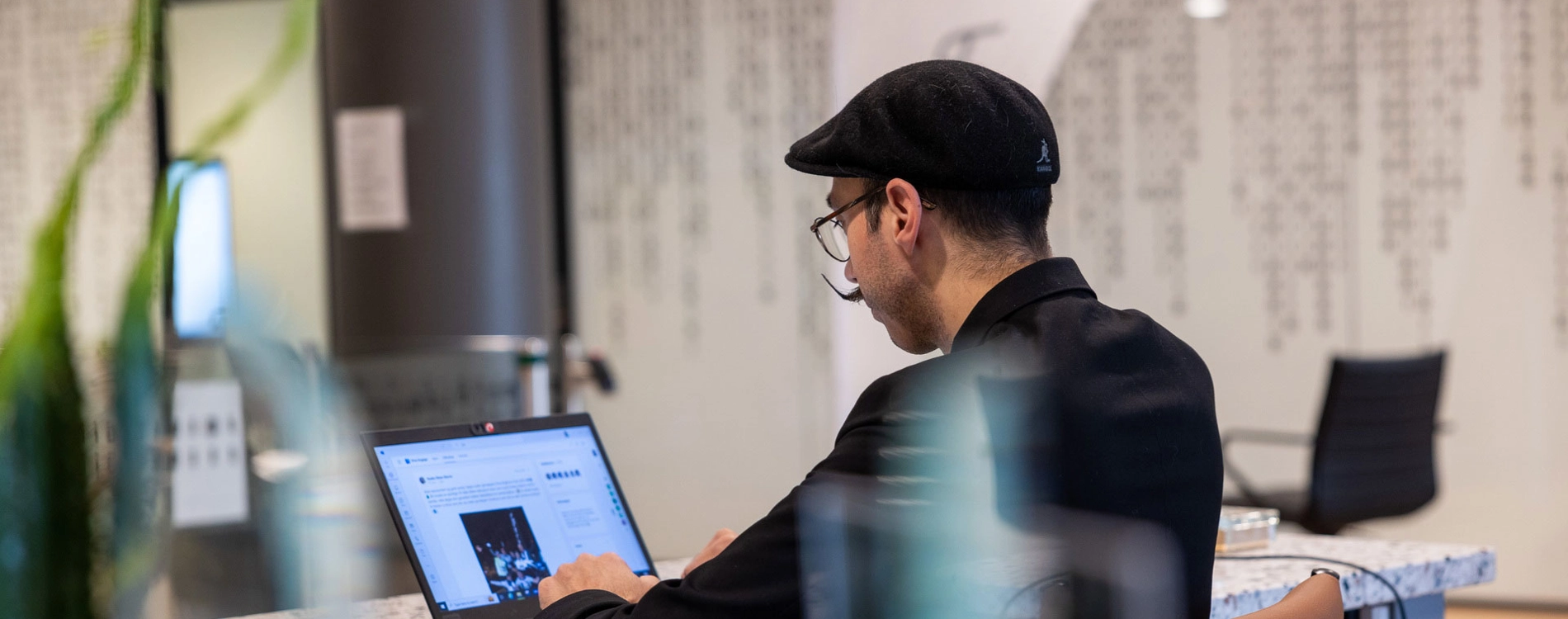 Man Sitting At Desk Working On Computer