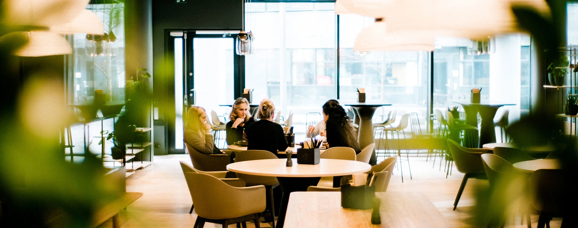 Five People Sitting Around A Table