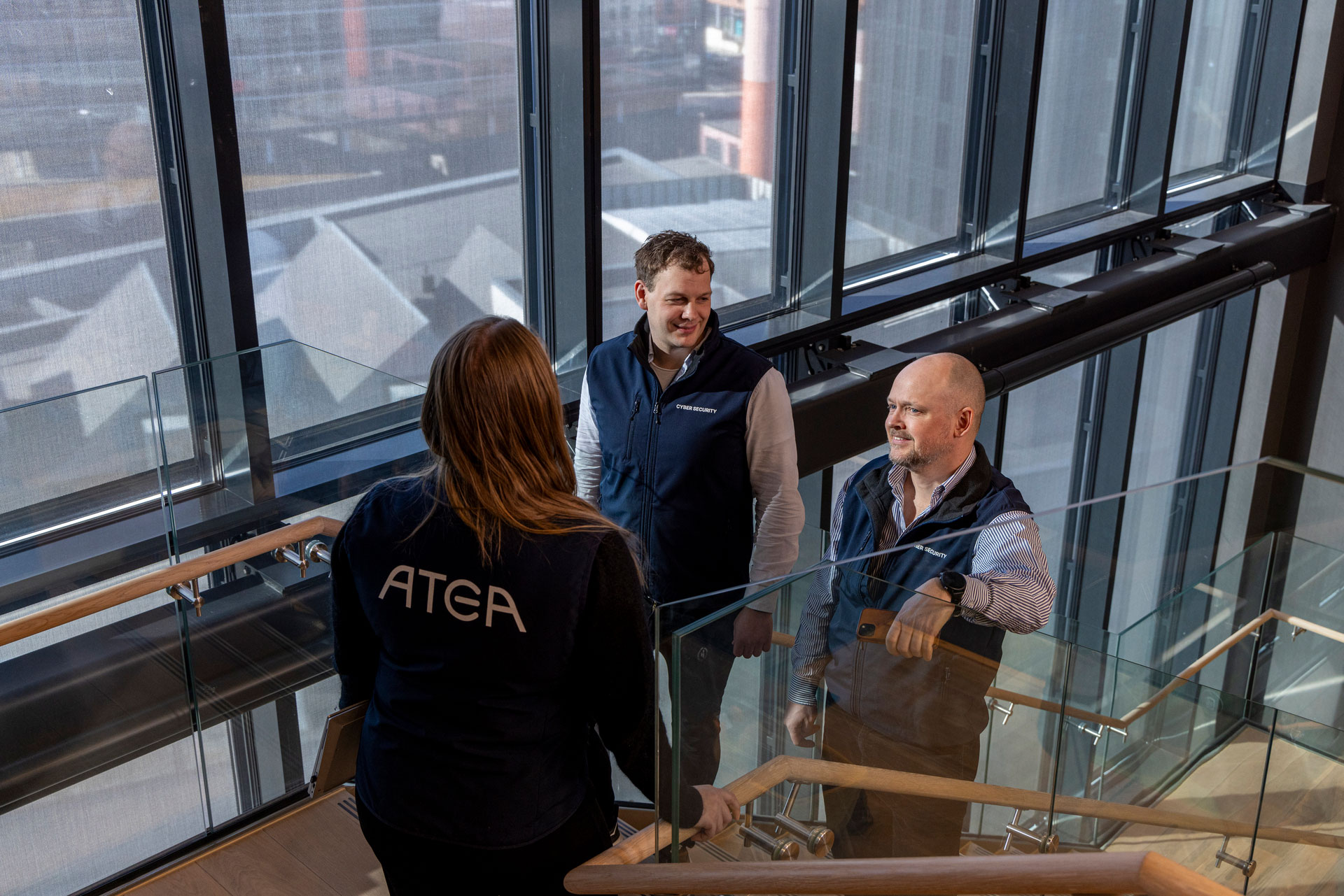 Three People Standing In Stairs