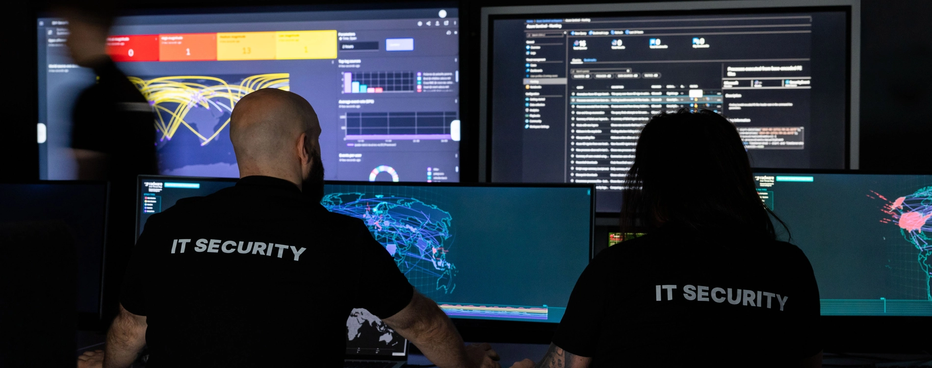 Two IRT persons in front of screens